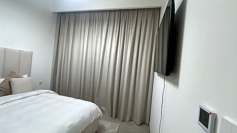Closed beige blackout curtains in a Dubai bedroom