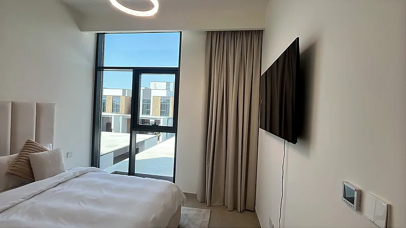 Bedroom curtains beside a full-height window