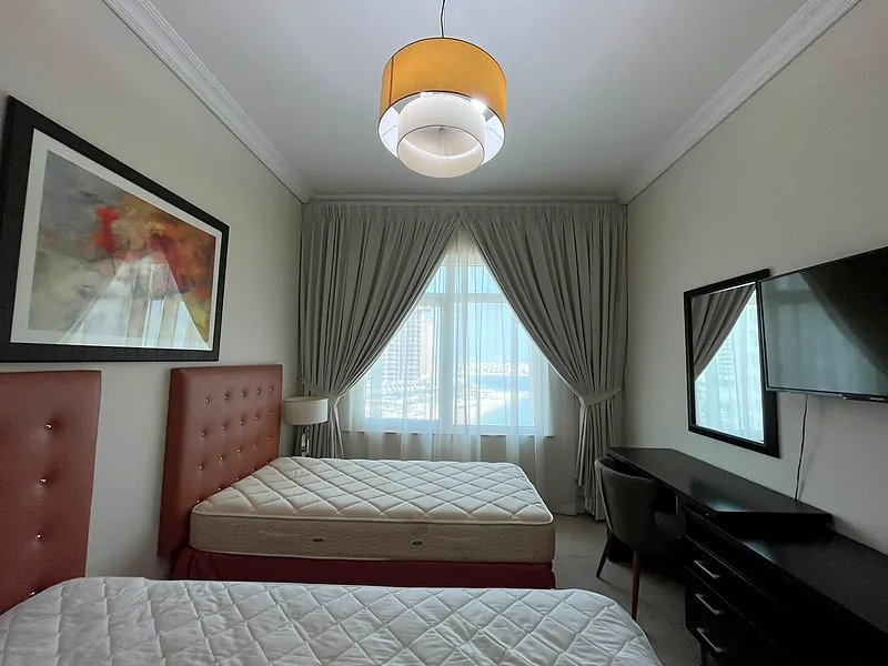 Pinch pleat curtains with sheers in a bedroom
