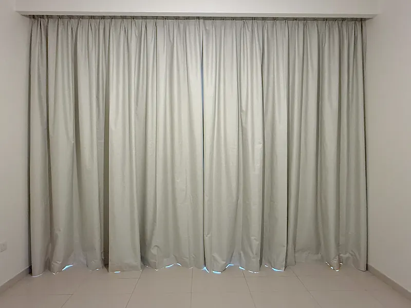 Wall-to-wall blackout curtains in a Dubai bedroom