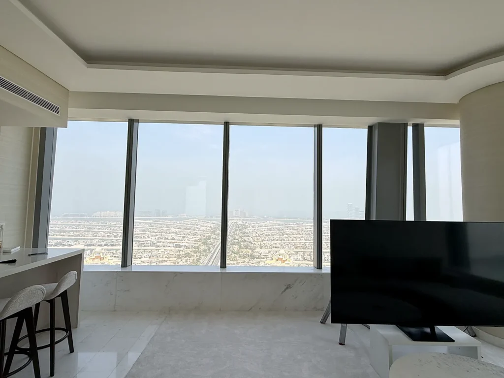 Ceiling track curtains with sheers in a high-rise living room, Dubai