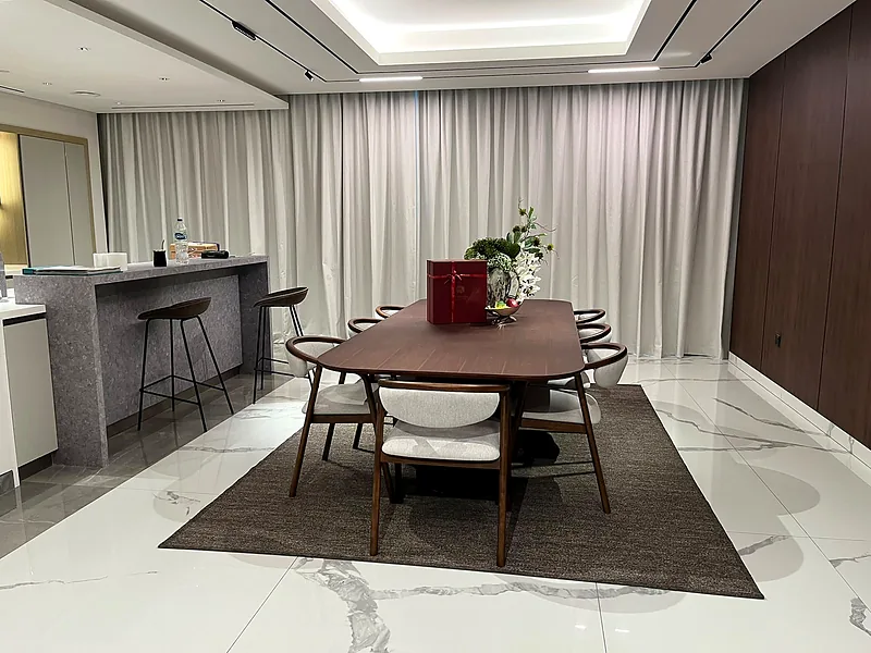 Ceiling-track curtains behind a dining table