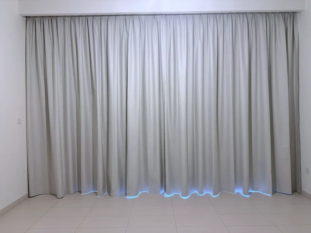 Grey blackout curtains covering a full wall in Dubai
