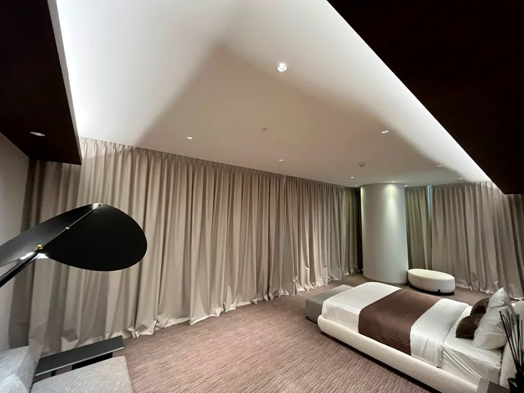 Hotel-style bedroom curtains installed wall to wall