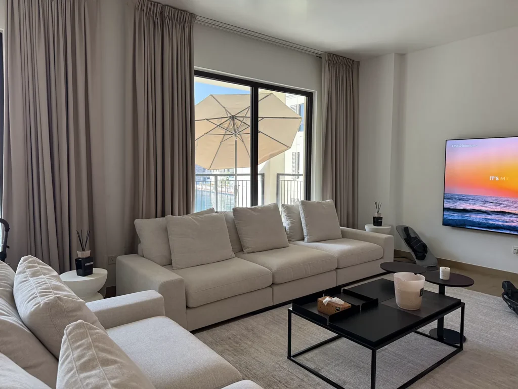 Floor-length curtains on terrace doors in a Dubai living room