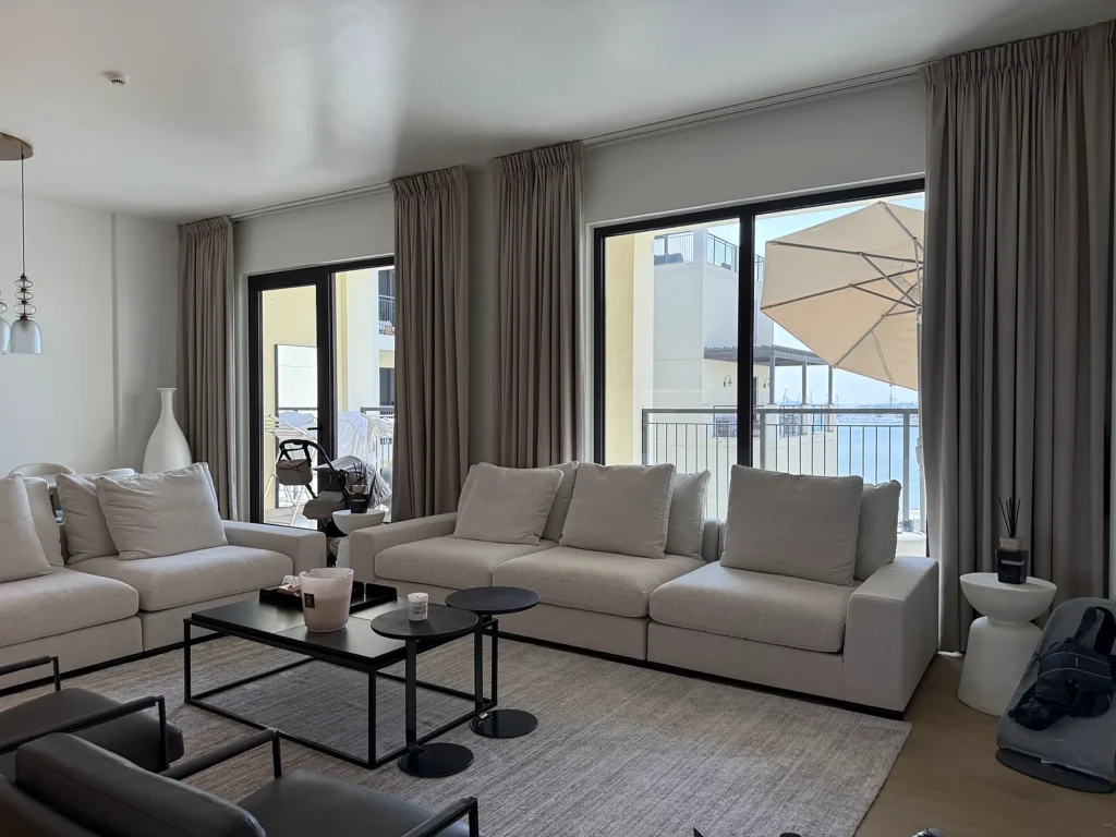 Grey ceiling-track curtains on sliding doors in a Dubai living room
