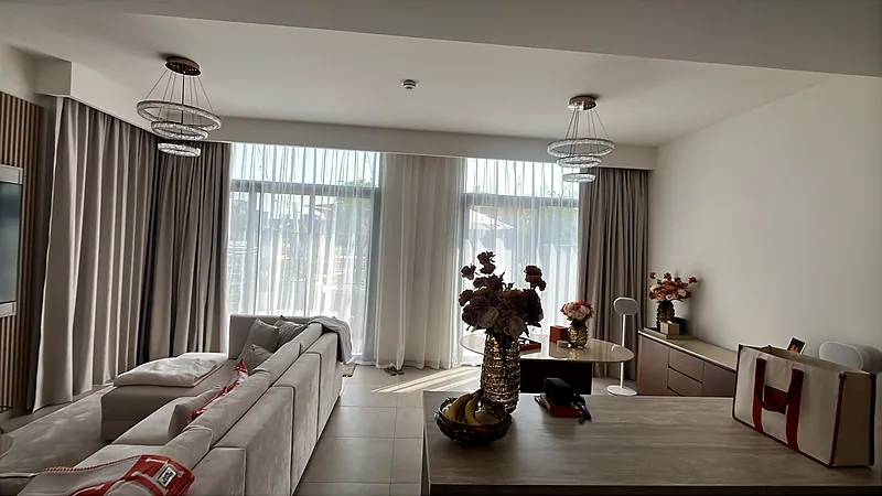 Sheer and dim-out curtains layered in a Dubai living room