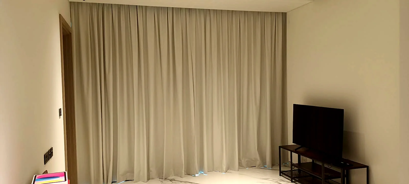 Ceiling-recessed wave curtains installed in a Dubai living room